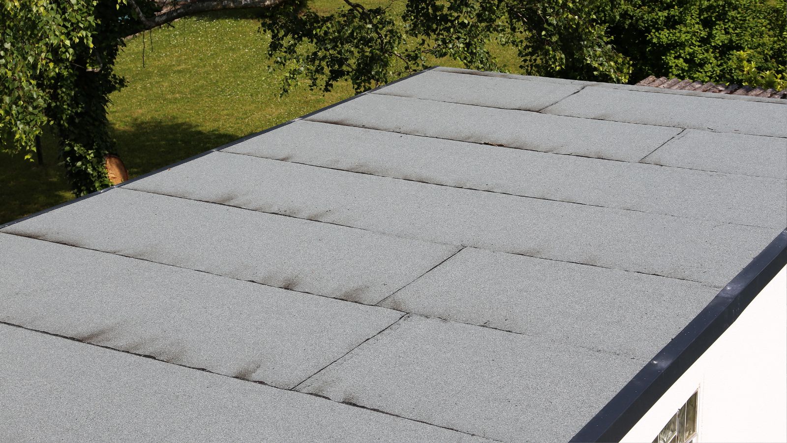 Applying a topcoat to a GRP flat roof